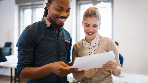 Two colleagues reviewing a document.